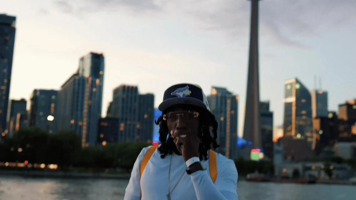 Guest in a blue cap beside the Toronto waterfront
