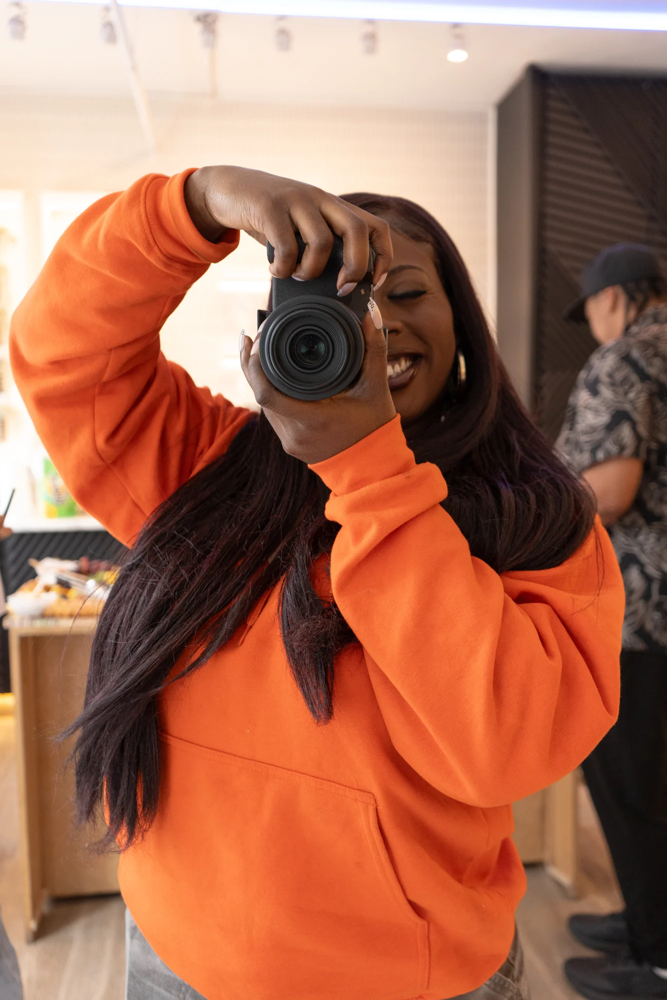 A photographer looking through a camera during a session