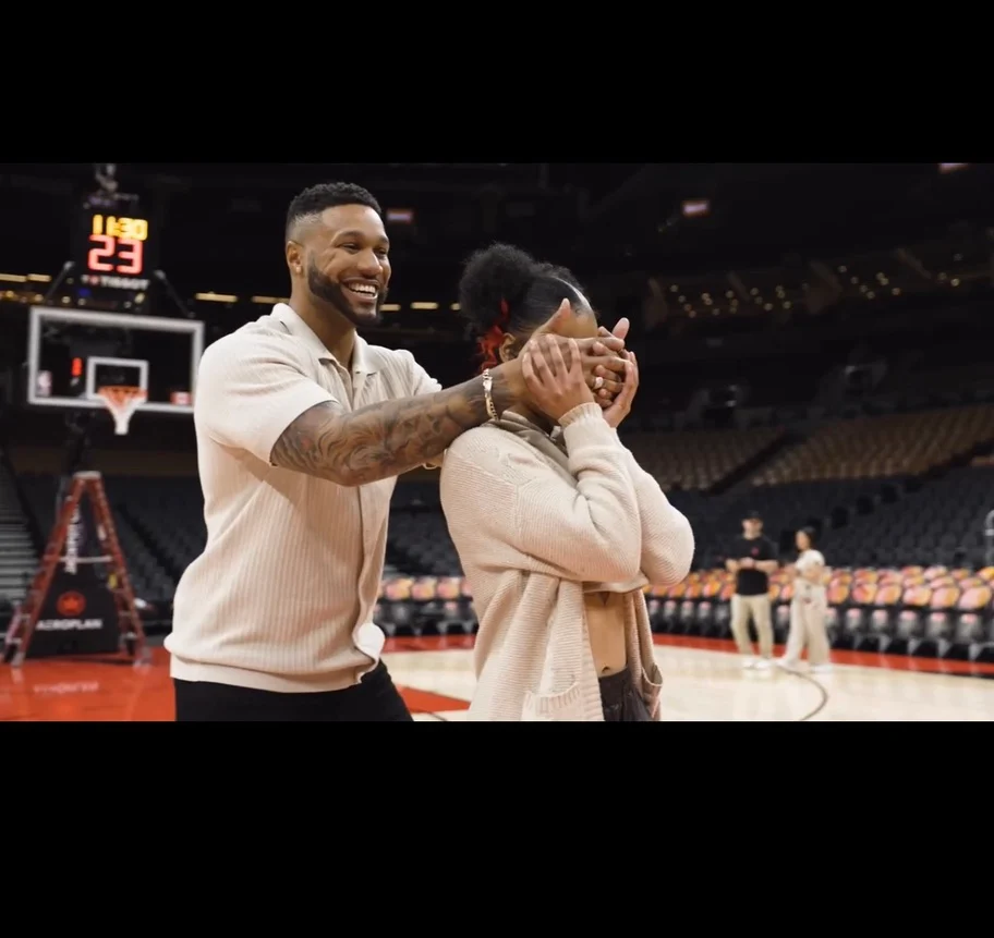 People greeting each other beside a basketball court