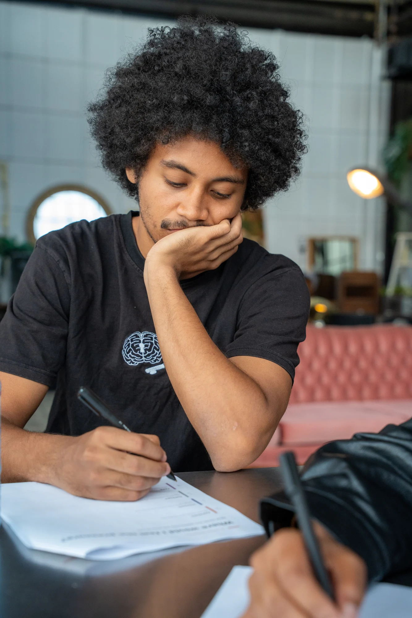 A Creative Longevity participant reflecting over written notes