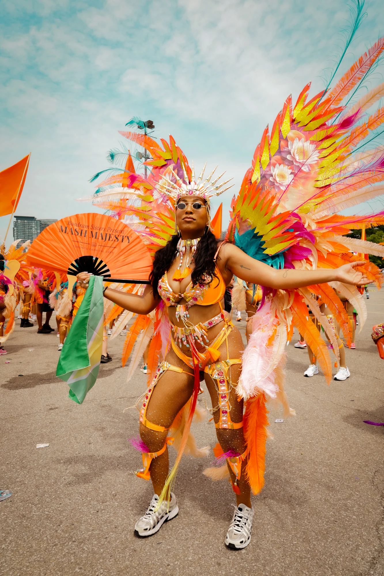 Performer standing along the Carnival route