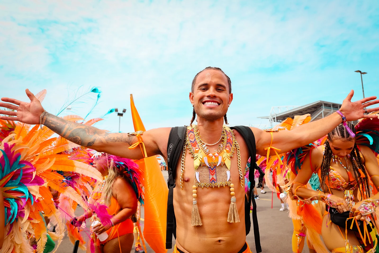 Carnival performer with arms outstretched beneath the sky