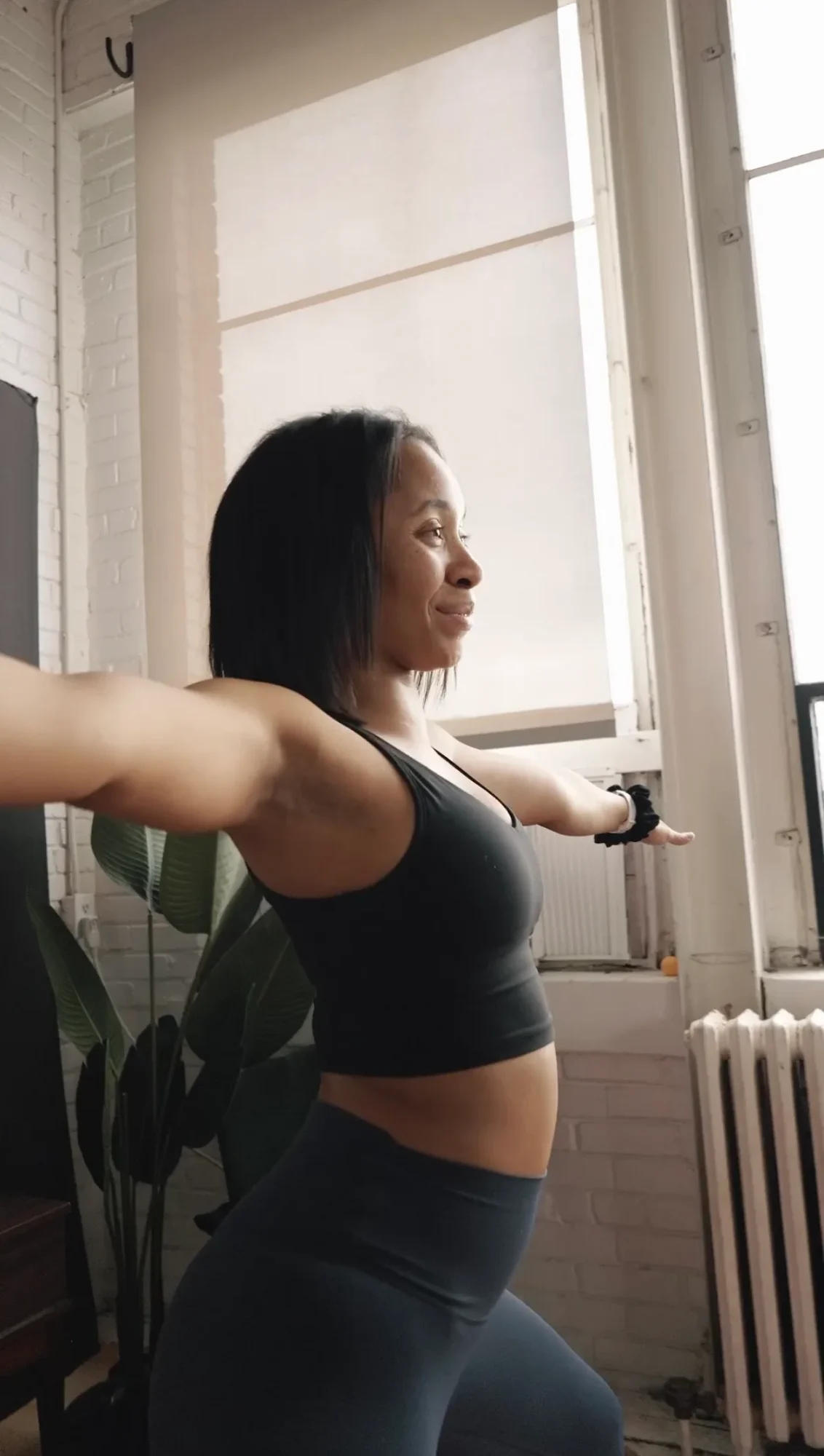 Participant stretching beside a studio window