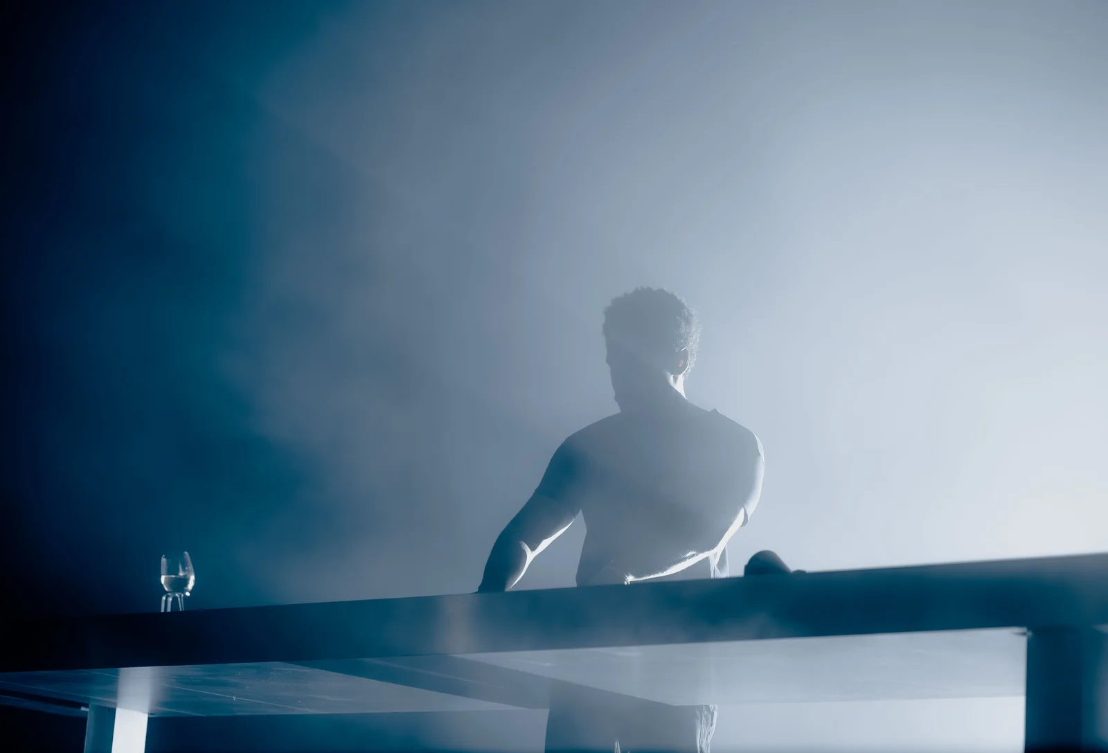 Performer on a stage with blue lighting