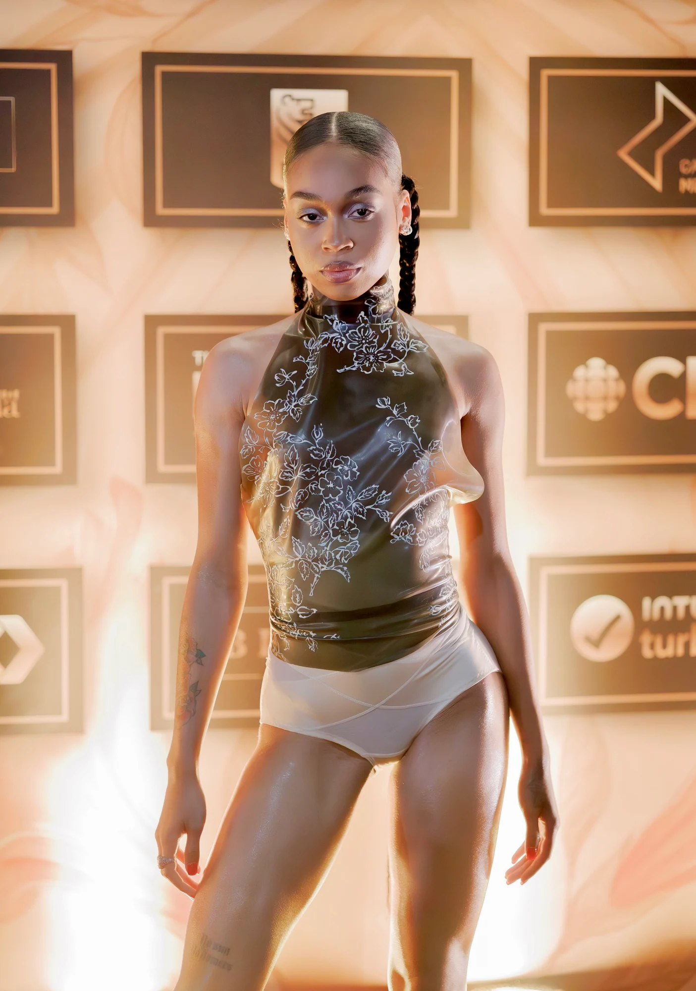 Person at an event against a step-and-repeat backdrop