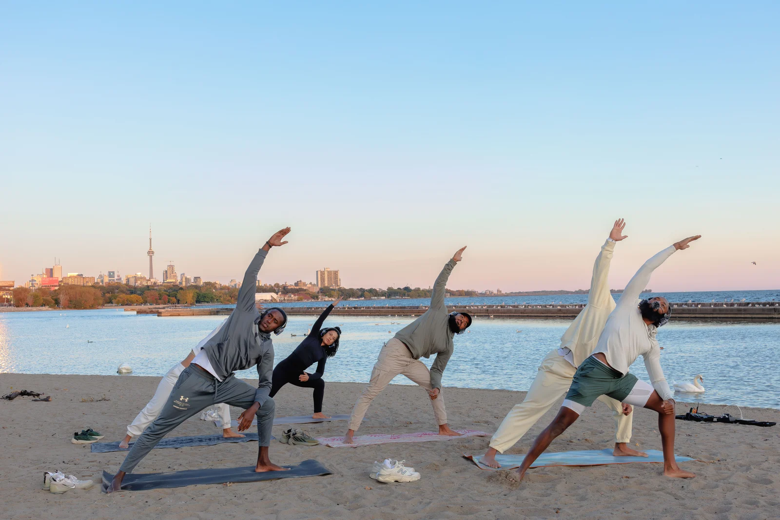 People stretching beside the water