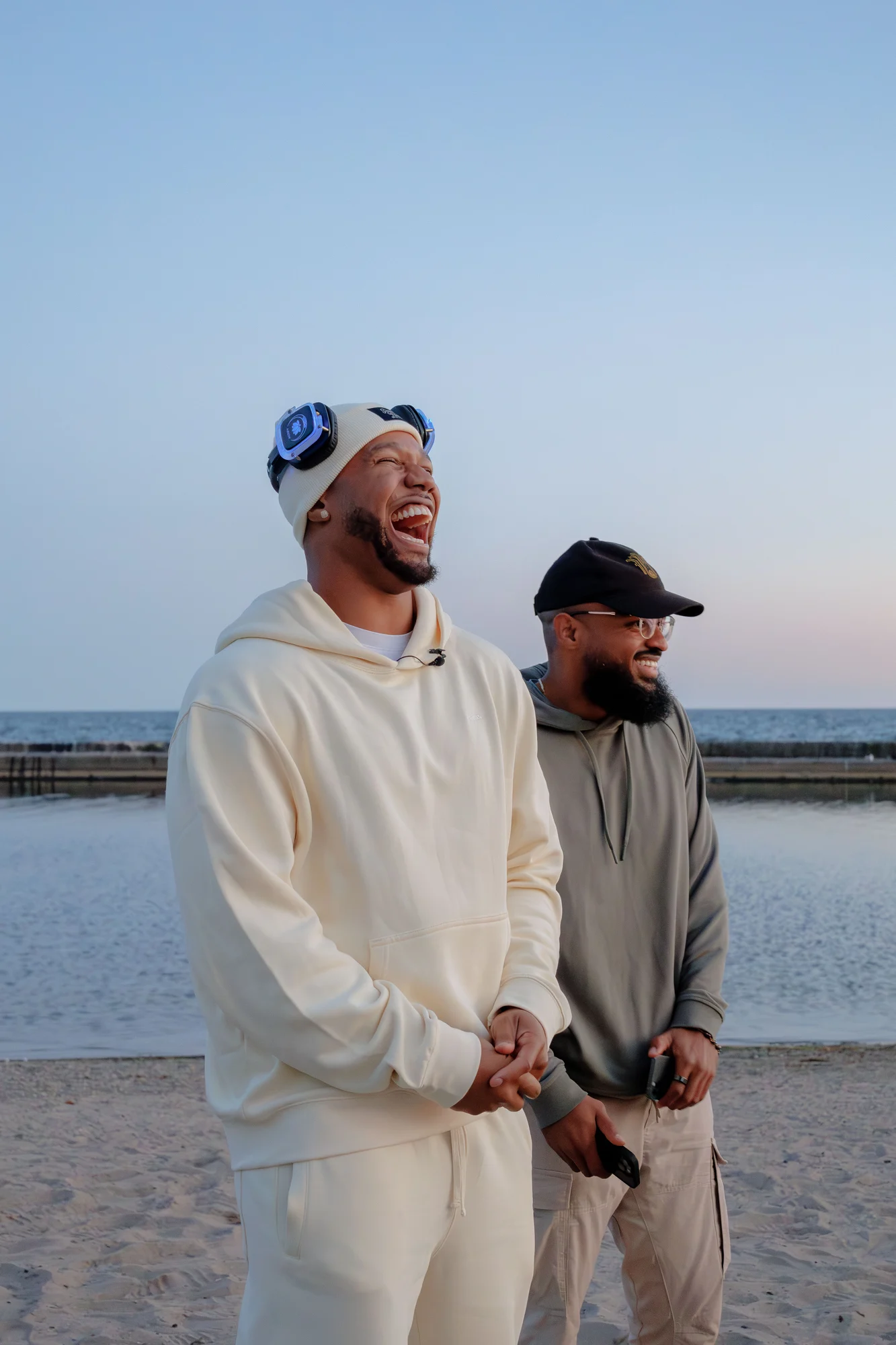Two people laughing beside the waterfront