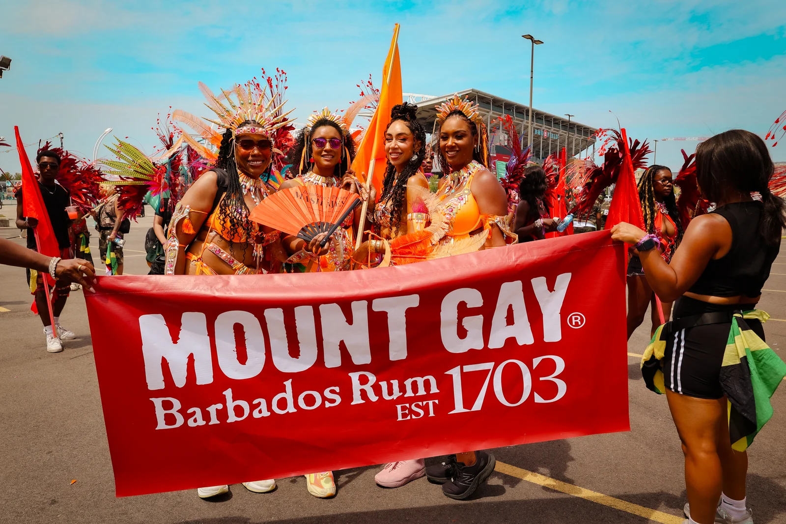 Carnival participants gathered behind a banner